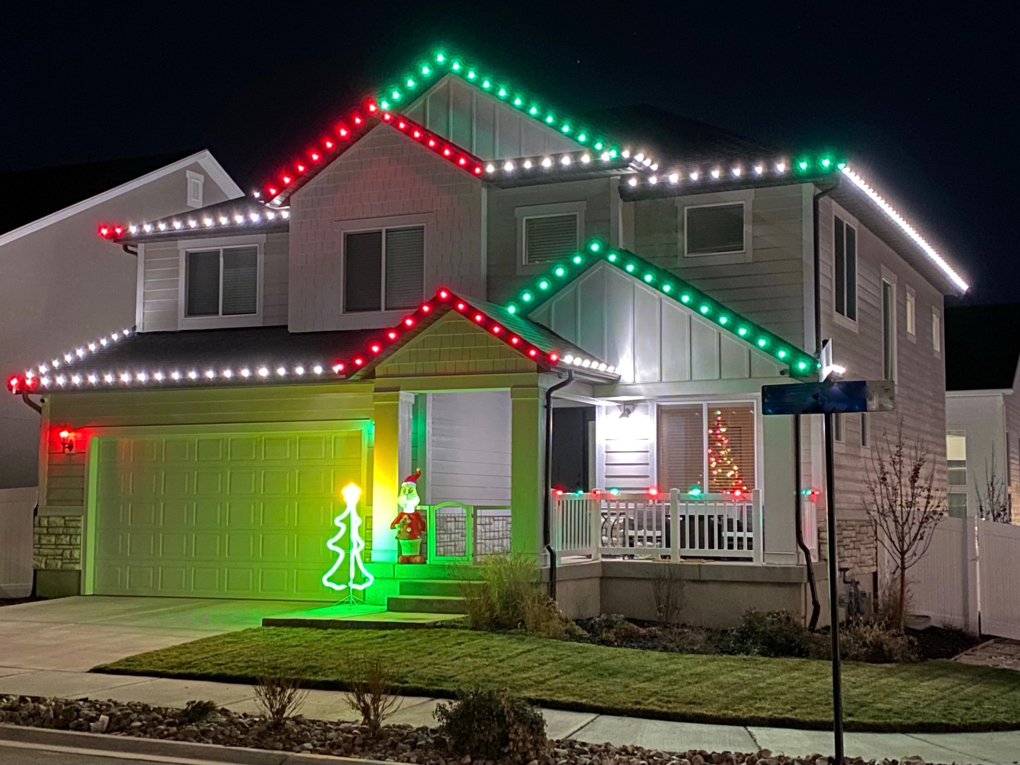 Home decorated with red, green, and white Christmas lights